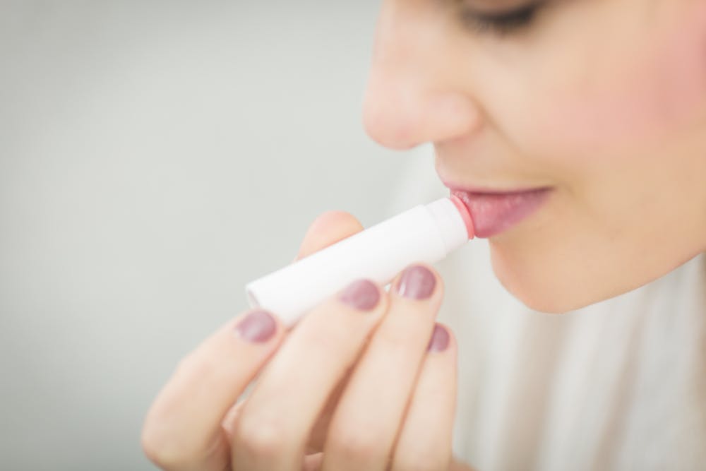 woman-applying-lip-balm